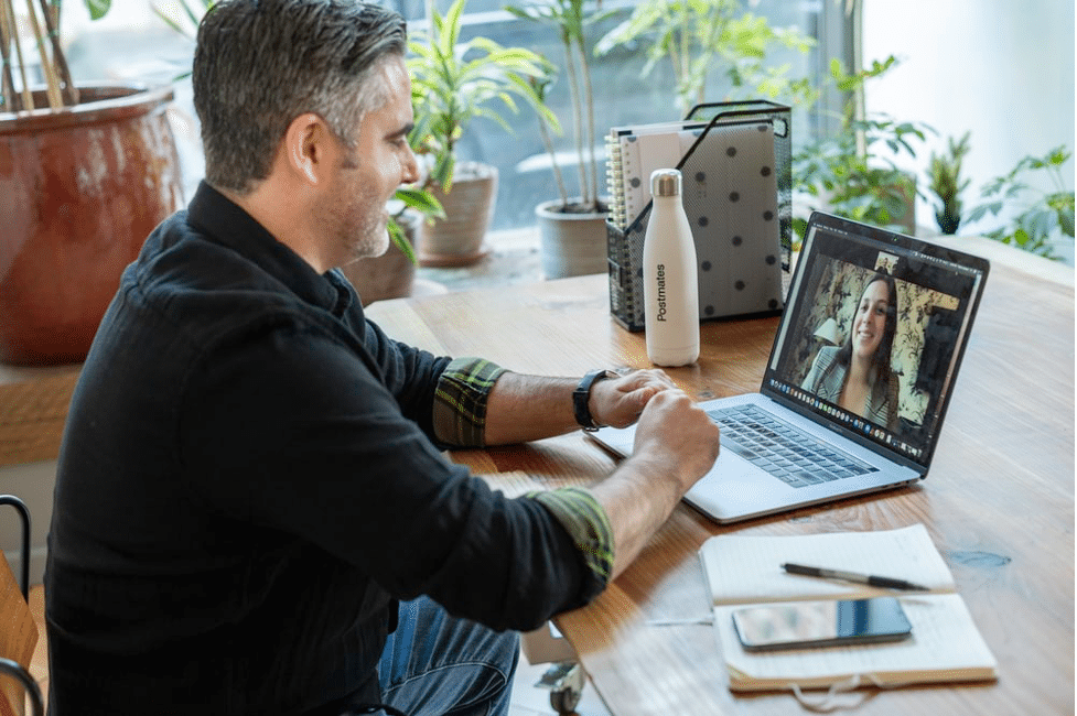 Man at desk having virtual conference call